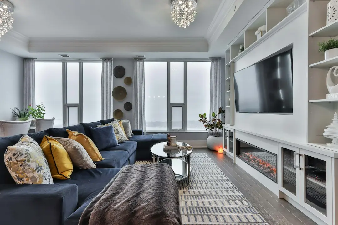 A bright living room with a wall-mounted TV, switched off, above a fireplace: the kind of screen TvNado streams to over an internet connection